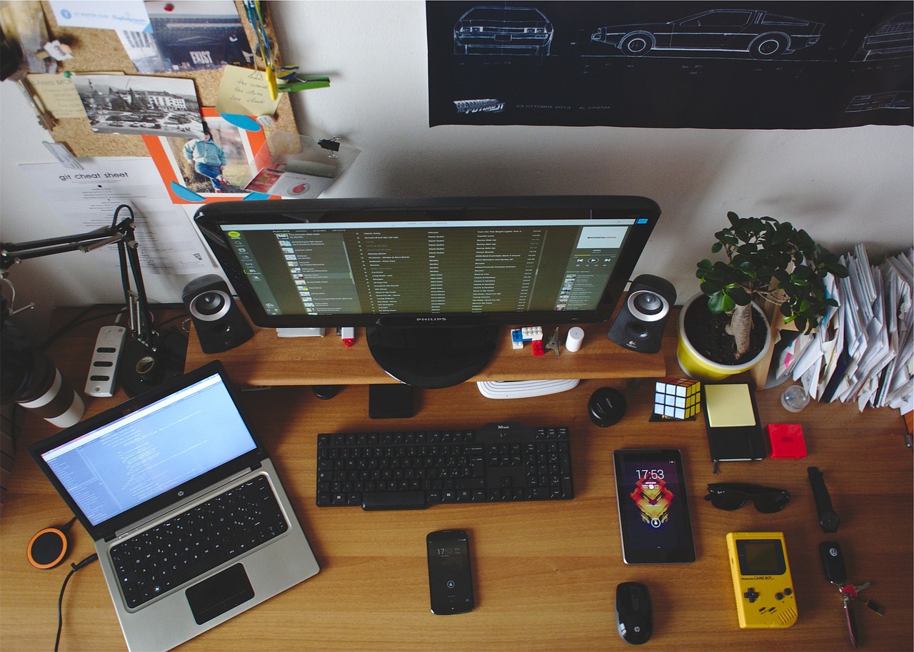 desk, office, room, laptop, hp, monitor, keyboard, computer, pc, cell phone, mobile, mouse, gameboy, sunglasses, rubix cube, keys, post-it notes, papers, technology, desk, computer, cell phone, gameboy, gameboy, gameboy, rubix cube, rubix cube, rubix cube, rubix cube, rubix cube