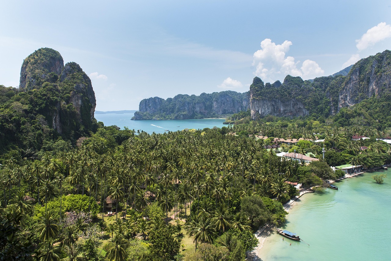 railay bay, krabi thailand, thai, thailand, travel, beach, sea, tropical, island, bay, rock, railay, summer, water, vacation, sand, cliff, paradise, coast, asia, tourism, boat, shore, coastline, sunny, seascape, blue, tropic, andaman, mountain, idyllic, ocean, landscape, krabi, nature, scenery, blue sky, sky, landmark, destination, journey, environment, park, holiday, green, forest, scenic, natural, relax, river