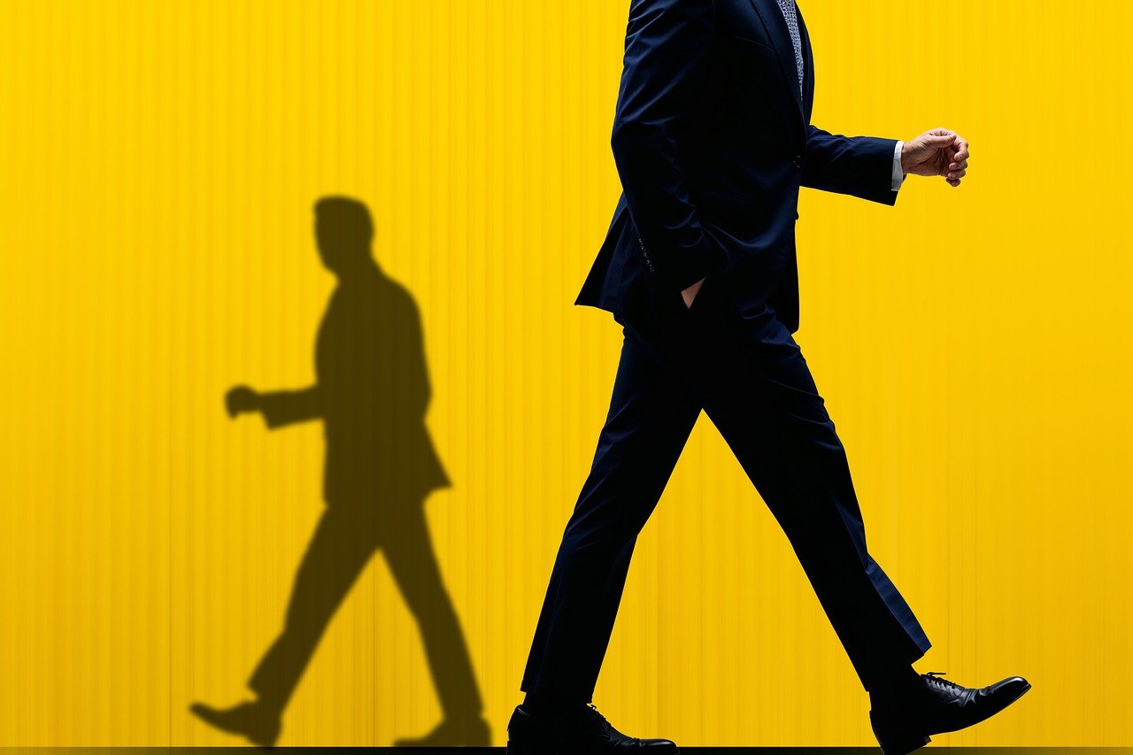 businessman, shadow, confidence, stride, professional, success, yellow, contrast, forward, ambition, corporate, power, movement, journey, pursuit, determination, anonymity, leadership, abstract, bright, ai generated