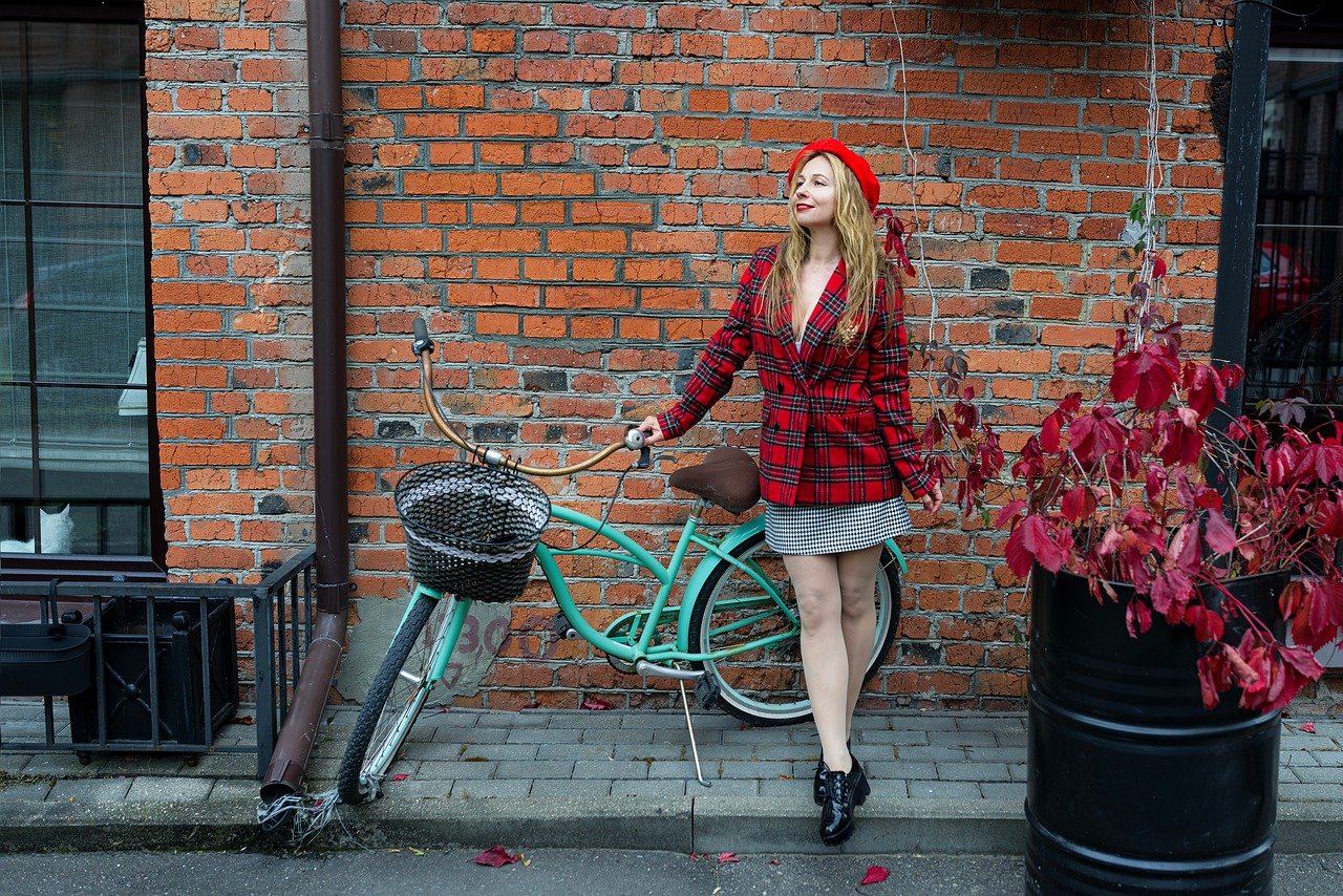 woman, autumn walk, red jacket, autumn clothes, demi-season clothing, brick, street, street photo, model, posing, femininity, beautiful, young woman, autumn, city, bicycle, loft